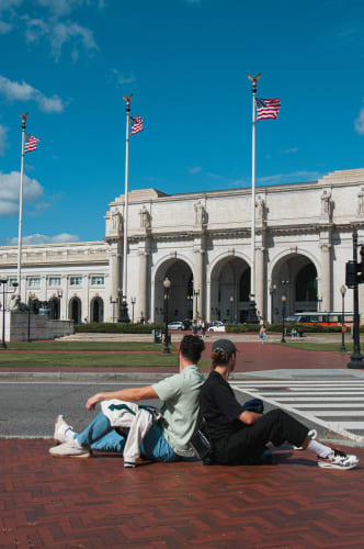 An image of a travel and architecture engaged in reading in a landmark.