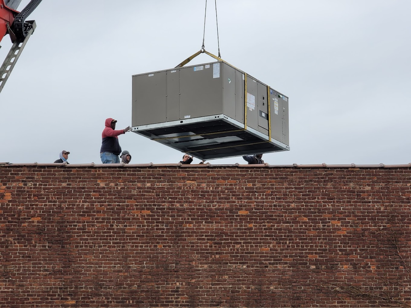 HVAC service technician working on air conditioning unit
