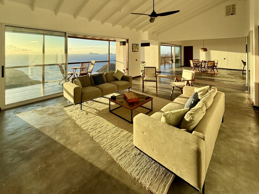 Penthouse living room flooded with golden sunrise light