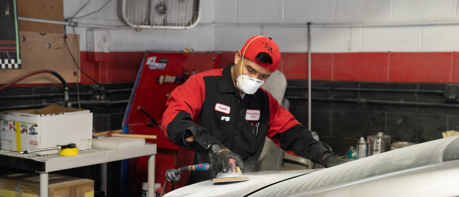Pristine Collision Center technician refinishing a panel