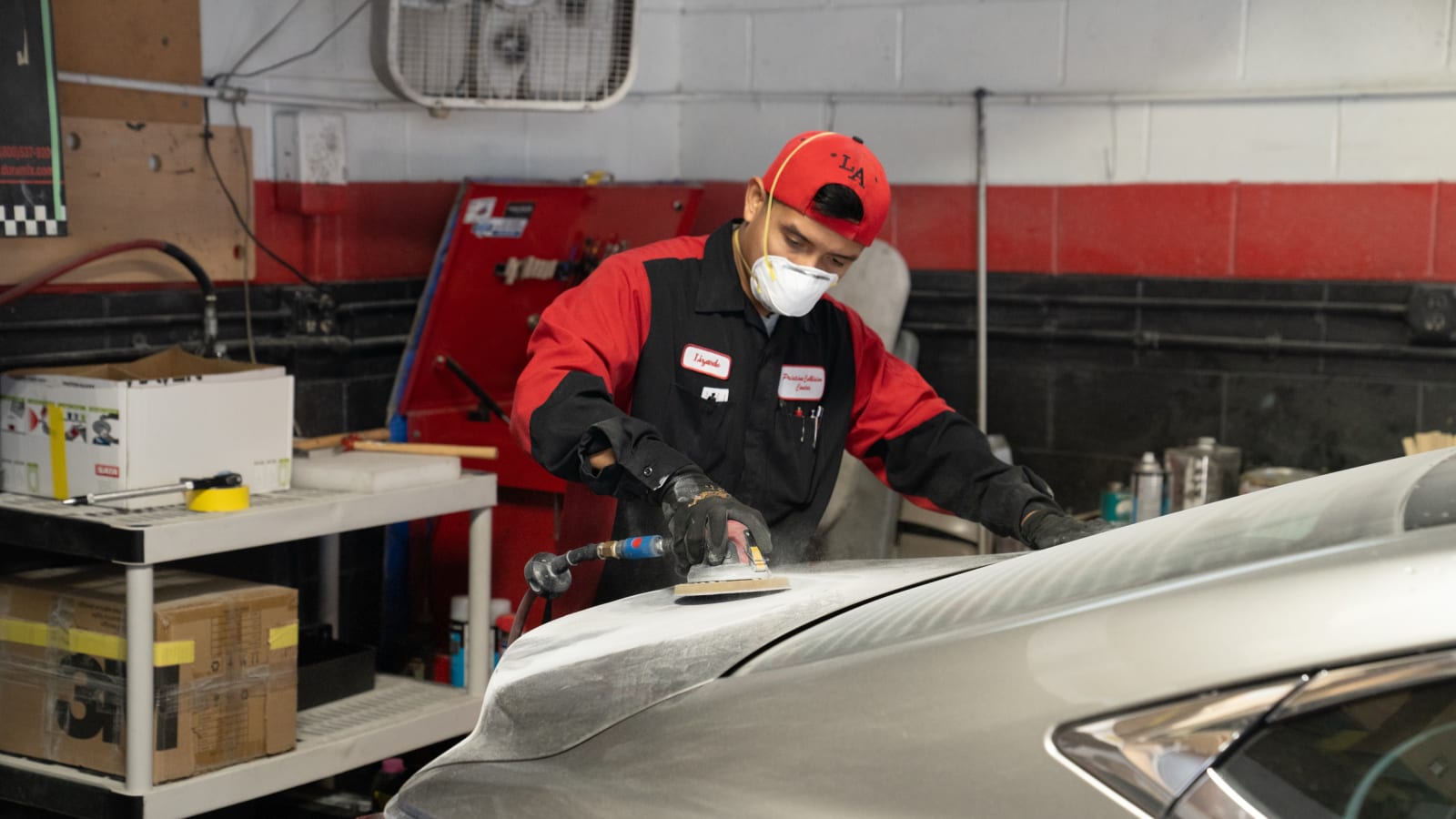 Pristine technician finishing a deck lid