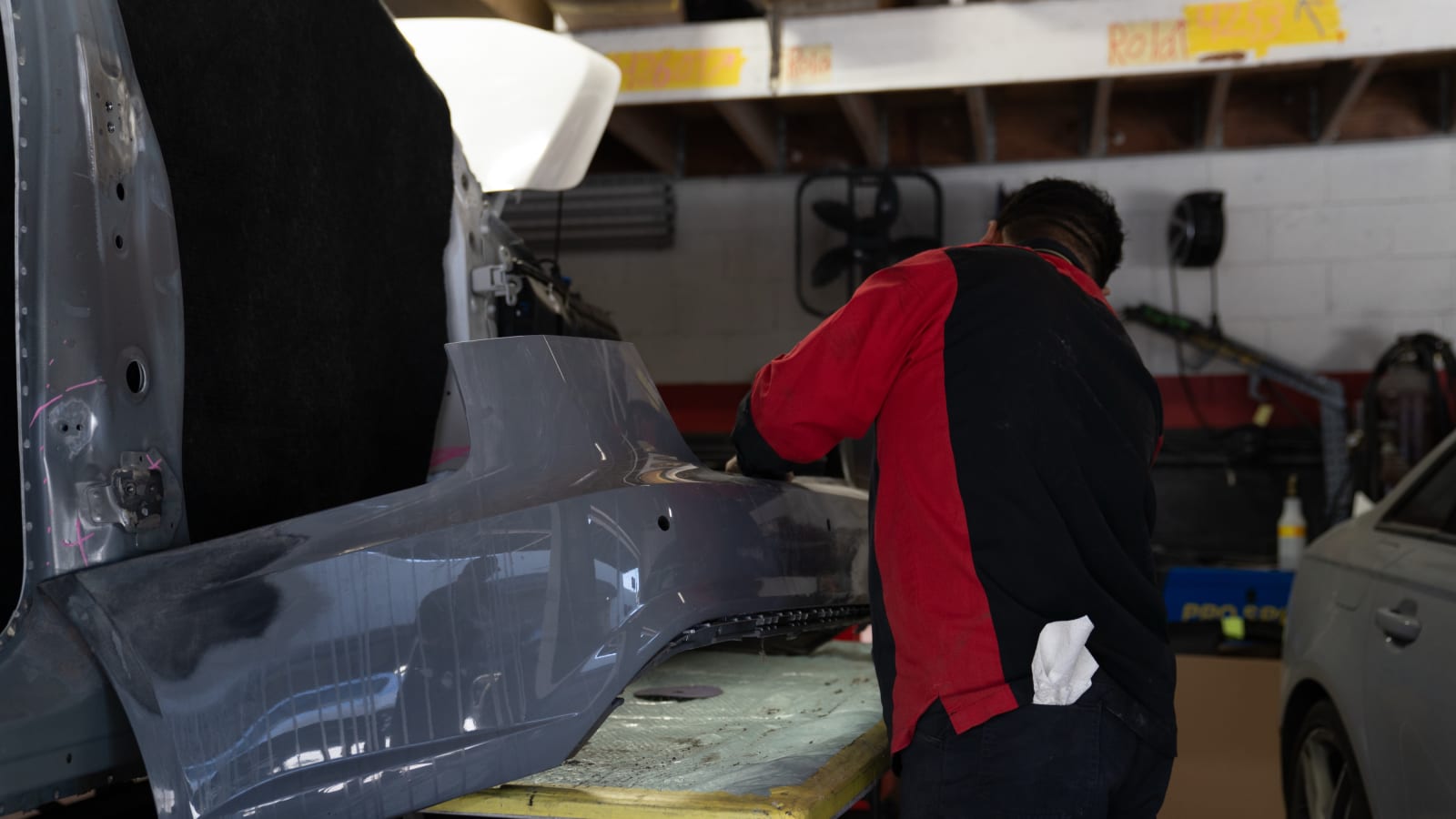 Pristine technician working a quarter panel