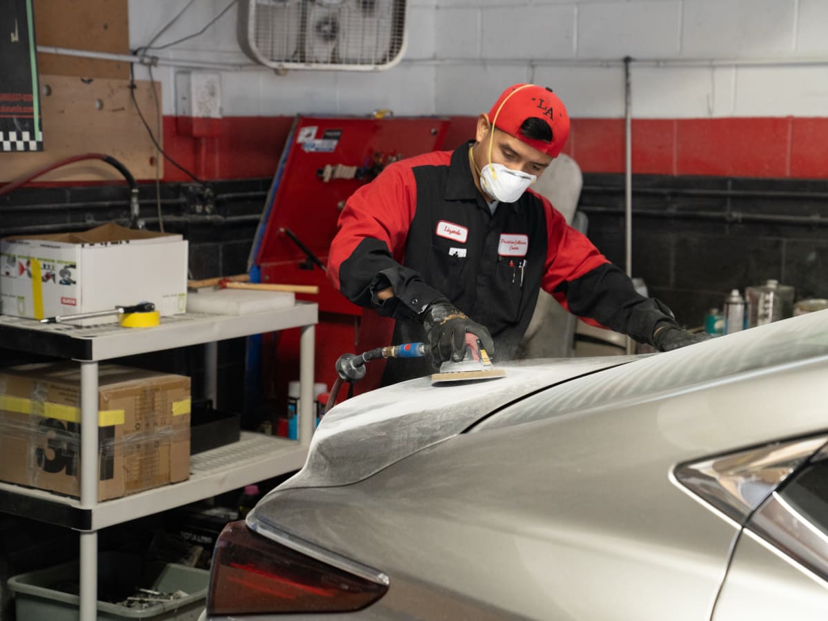 Pristine technician finishing a deck lid