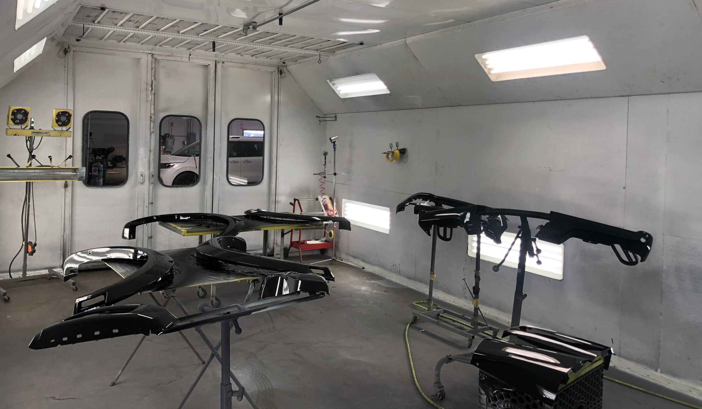 Parts prepped for paint inside the Advance Auto Body spray booth