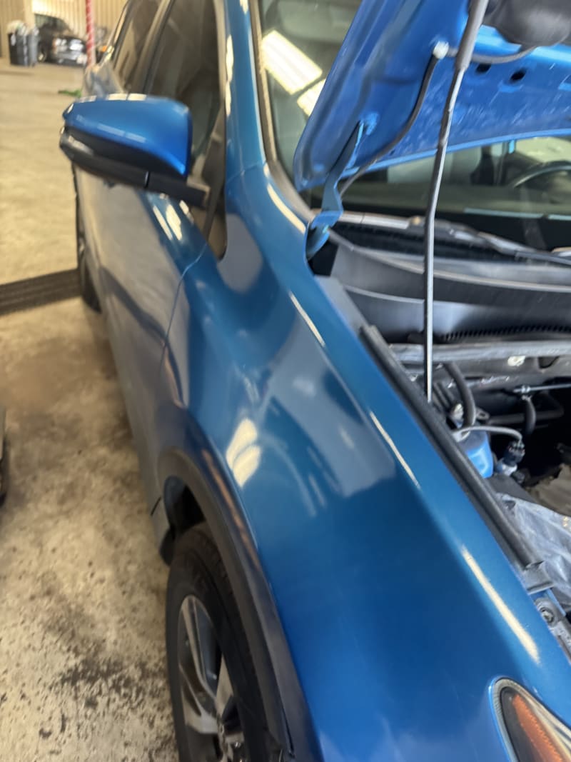 Blue SUV fender repair in progress