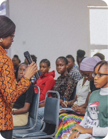 Young woman speaking at a leadership training session, demonstrating communication skills
