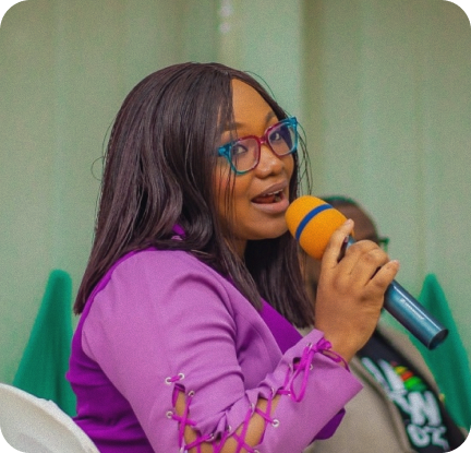 Woman speaking at a community event, demonstrating our responsibility to share knowledge and empower others