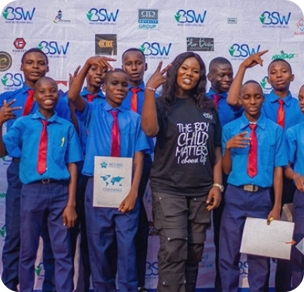 Group of young people in blue uniforms celebrating achievements at an iBSW program, representing our impact on youth development
