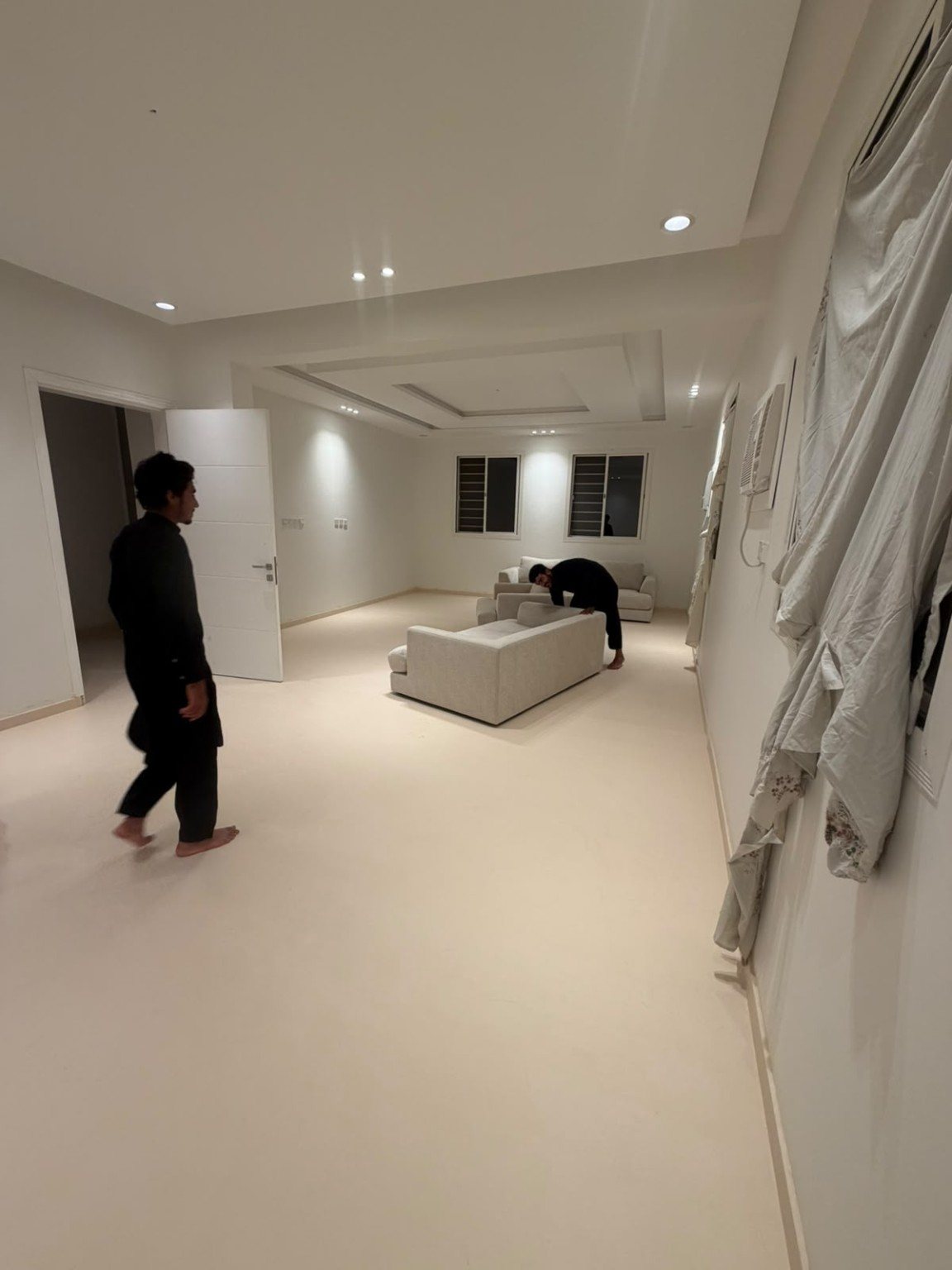 Open-plan luxury villa with seamless microcement flooring flowing through multiple zones