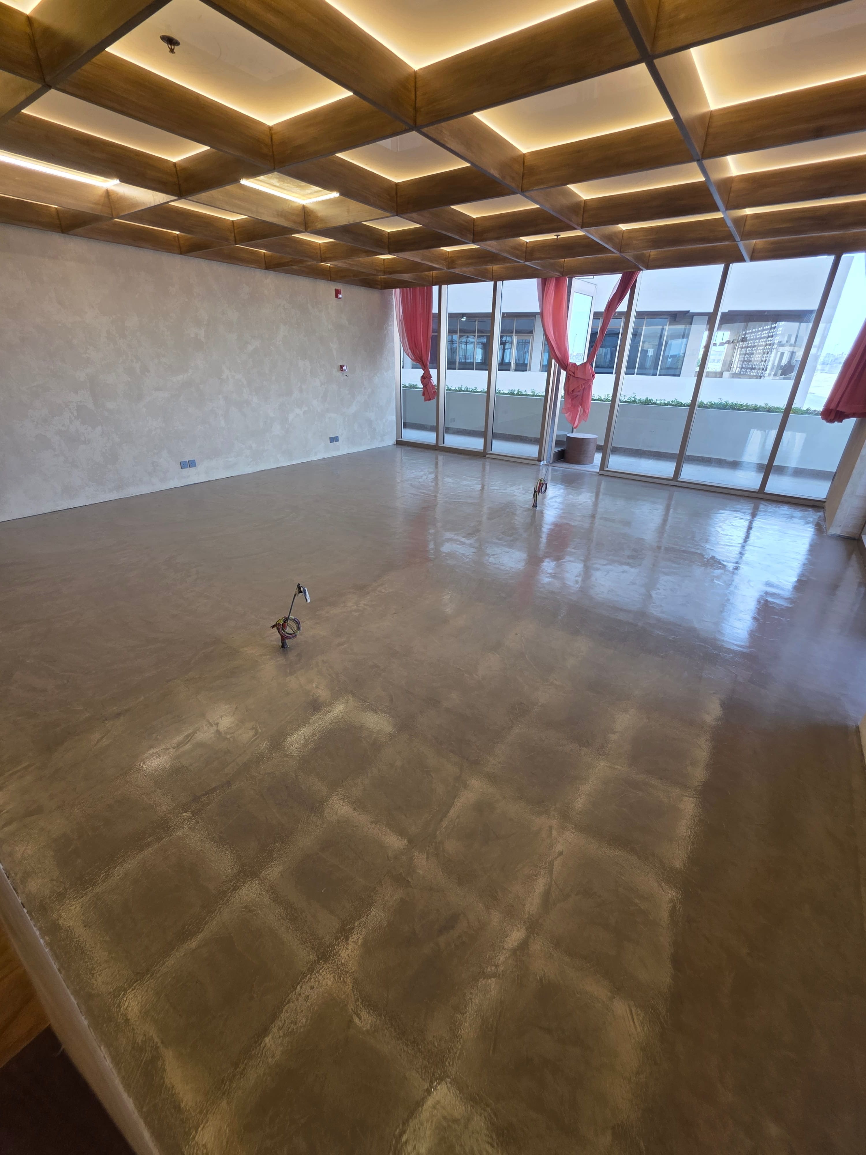 Industrial concrete-look microcement floor covering large open area with authentic texture