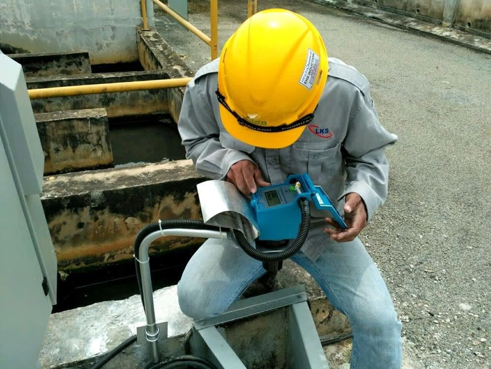 Engineer taking water quality measurements on site