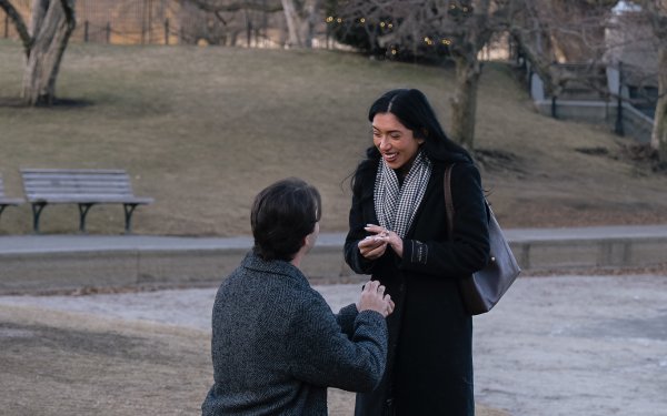 Couple celebrating engagement at Boston Seaport waterfront during golden hour