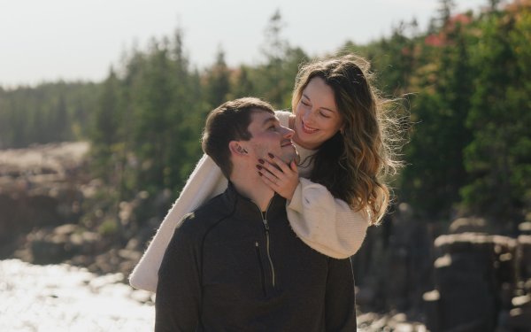 Engaged couple on rocky Maine coastline at Acadia Ocean Path