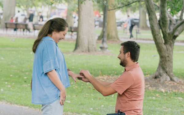 Couple celebrating engagement at Boston Public Garden with autumn foliage