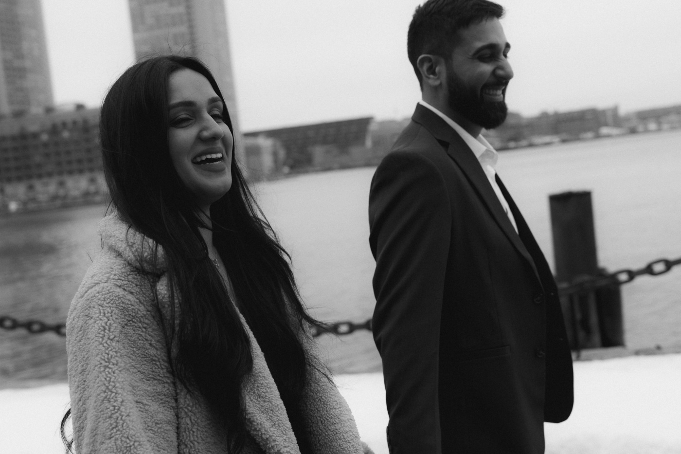Jay and Amrita with the city skyline behind them