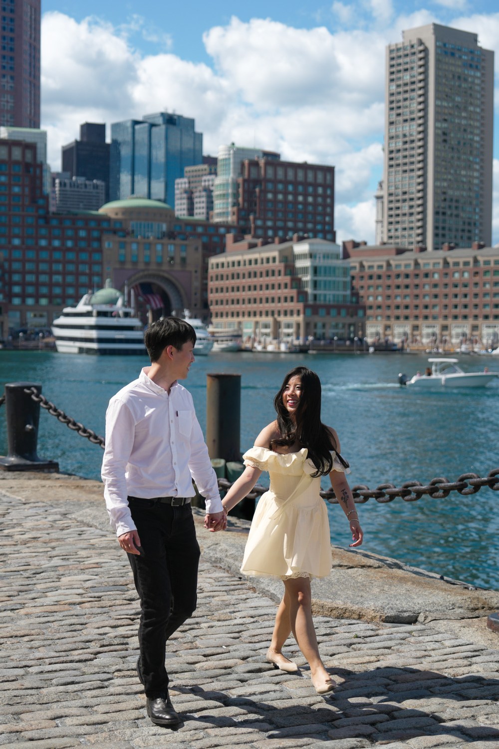 Daniel and Steffi at Boston Seaport with the city skyline behind them