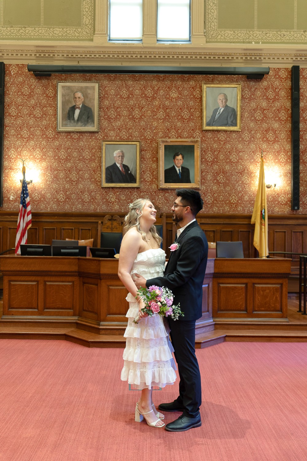Luis and Taylor on the Cambridge City Hall staircase after their wedding ceremony