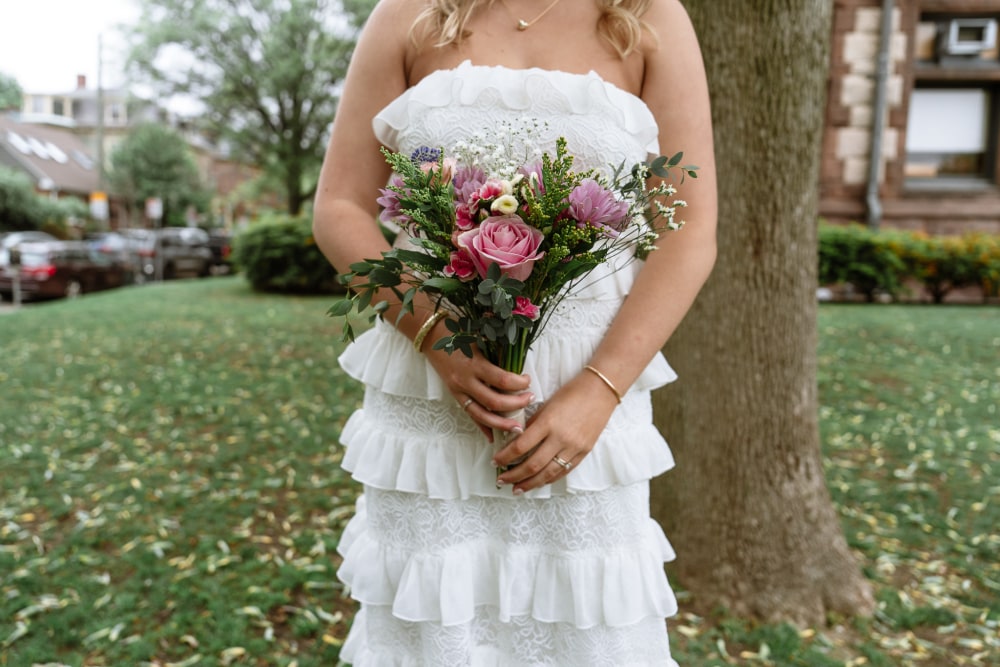 Bride holding her bouquet outside after a city hall ceremony
