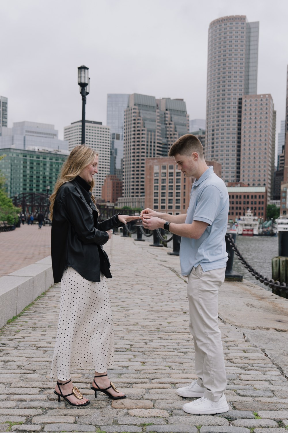 John and Hannah walking together at the Boston Seaport waterfront
