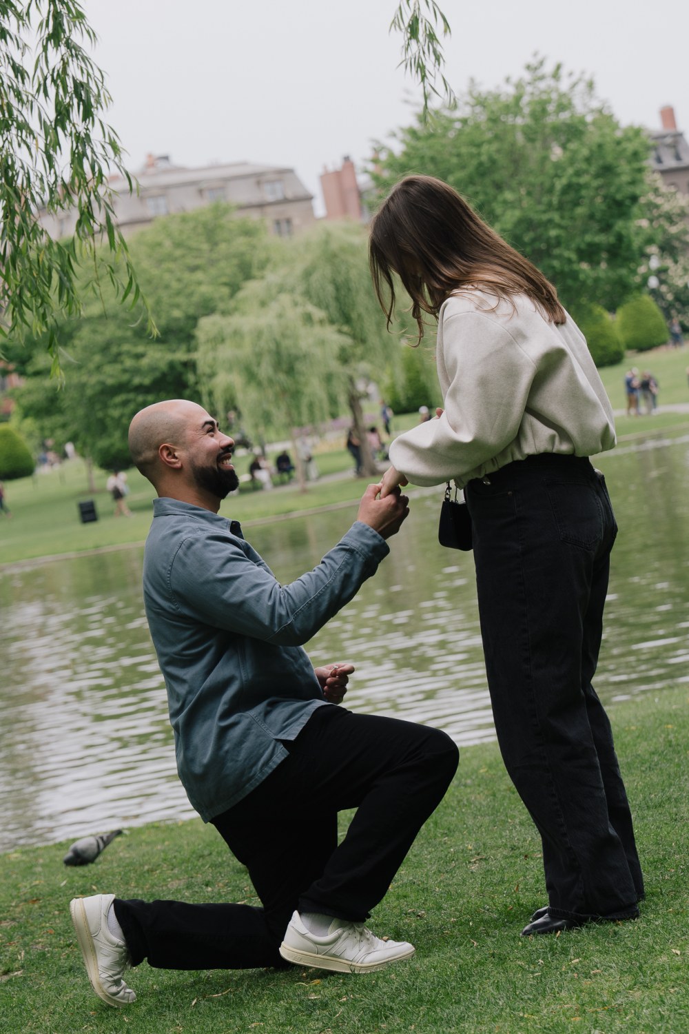 JJ on one knee proposing to Payton at the Boston Public Garden