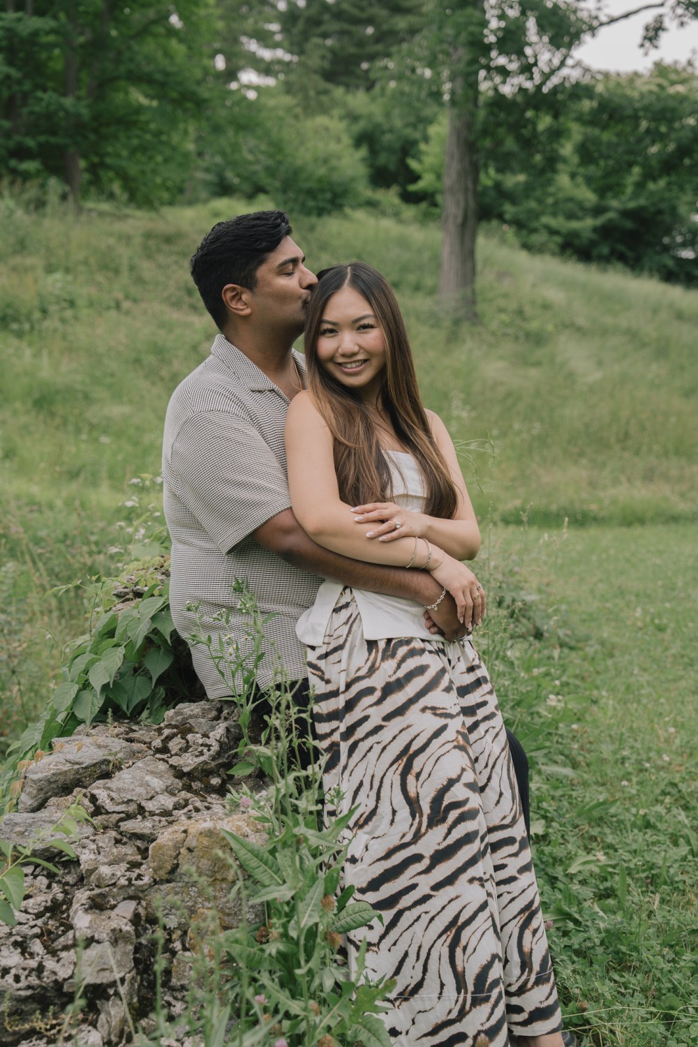 An engagement portrait among the evergreens in the conifer collection at the Arnold Arboretum