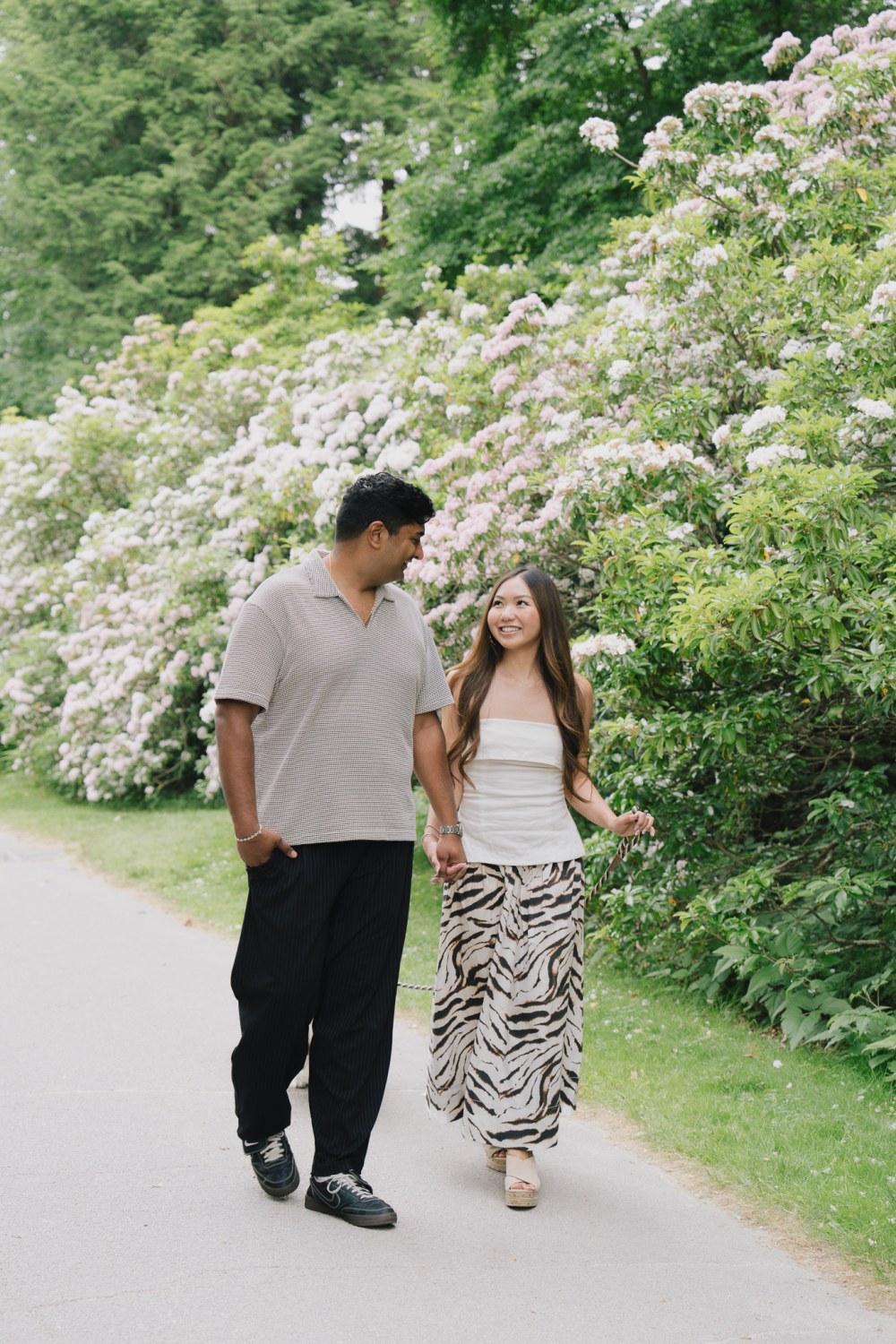 An engagement portrait on the open lawns at the Arnold Arboretum