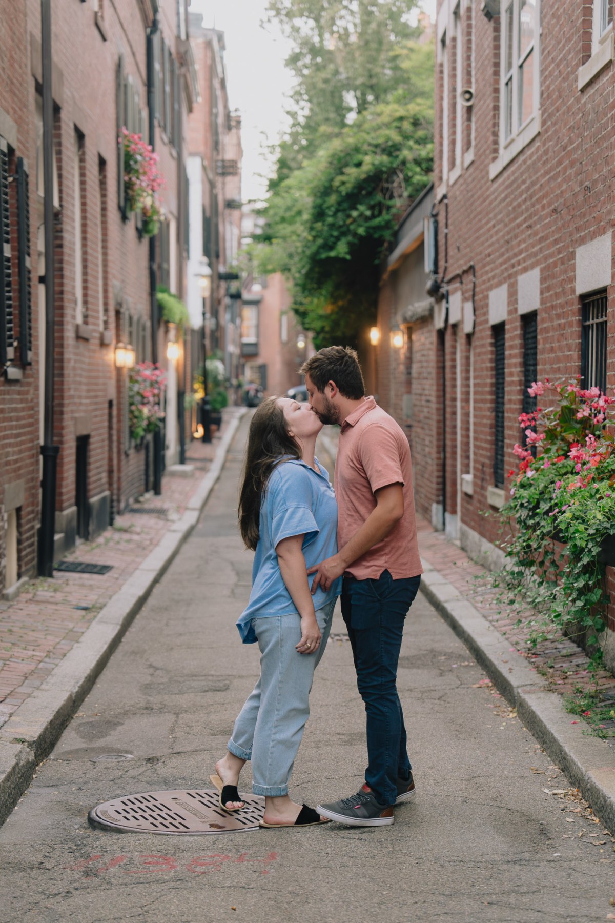 Alex and Kendyl walking arm in arm through historic Beacon Hill
