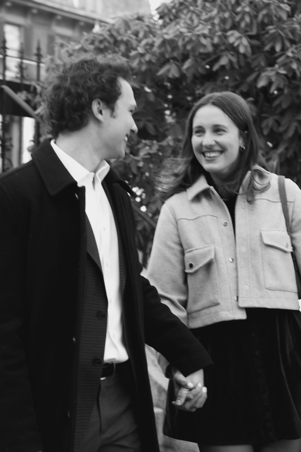 Gabe and Morgan standing close together on a South End brownstone street during their engagement session