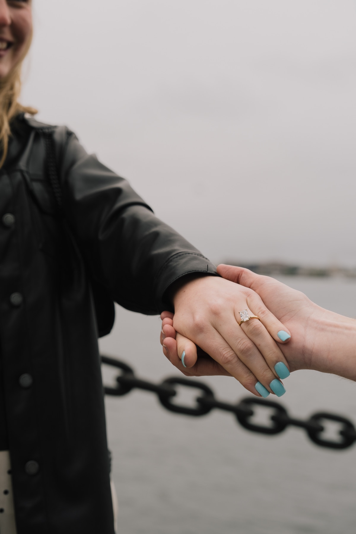 A couple embracing at the Boston waterfront with sunset behind