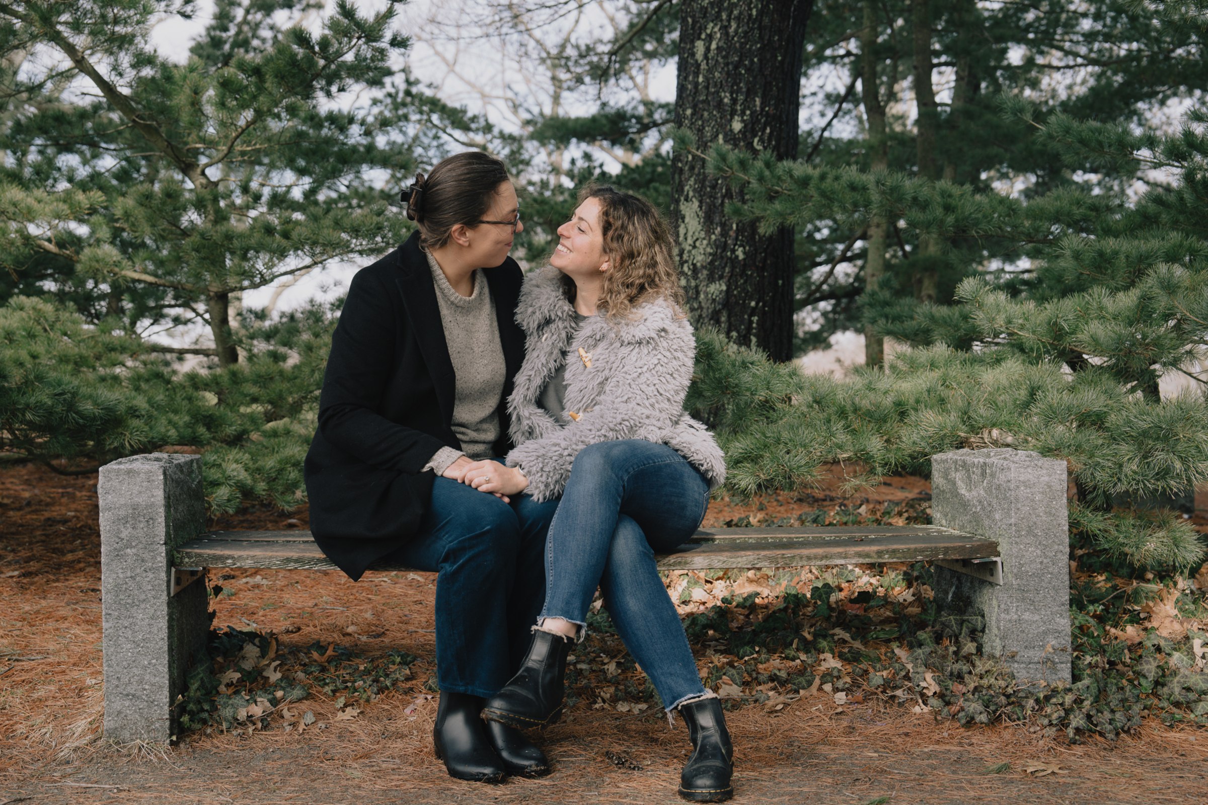 Laura and Sara laughing together among the trees
