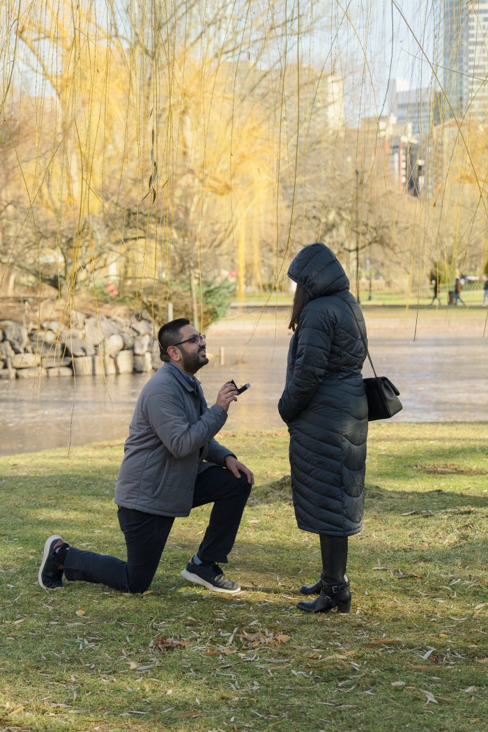 Brijesh starting to kneel during the surprise proposal