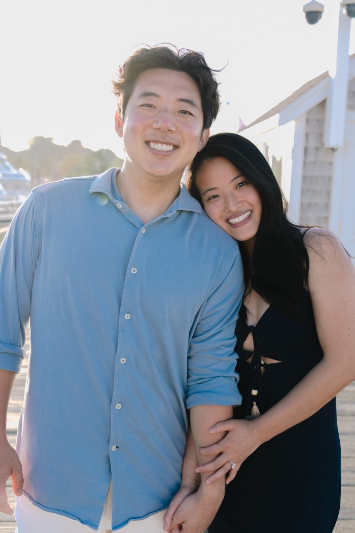 Joshua and Hannah close together on the pier