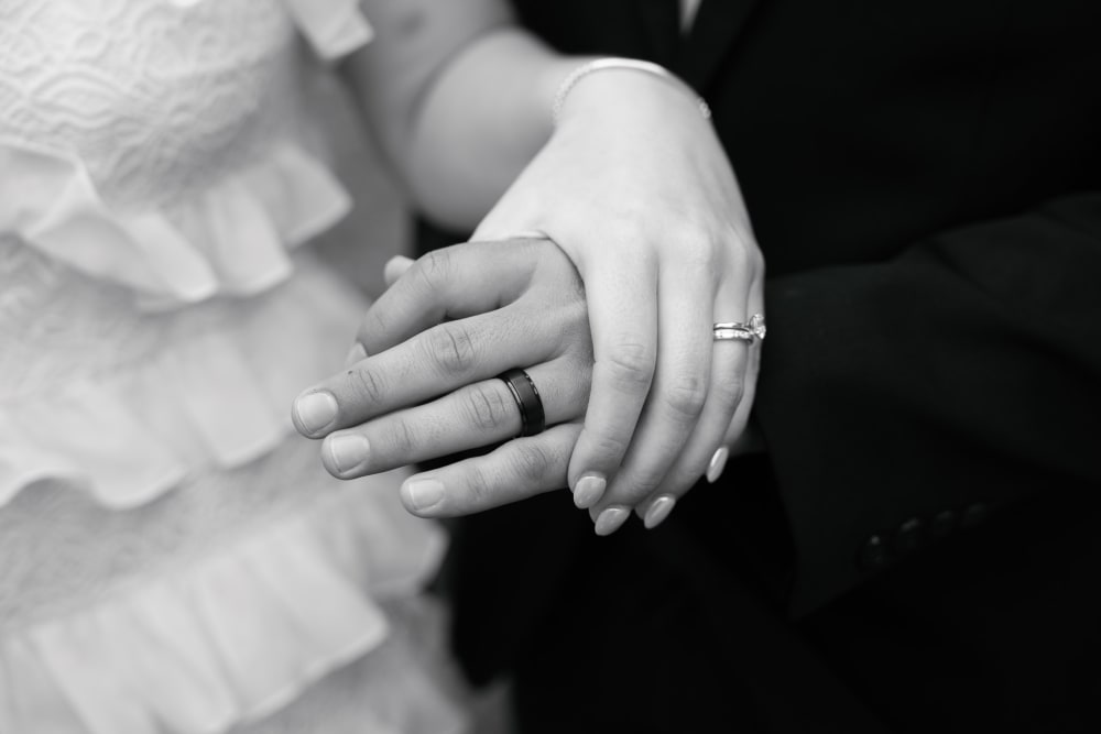 Wedding rings and joined hands