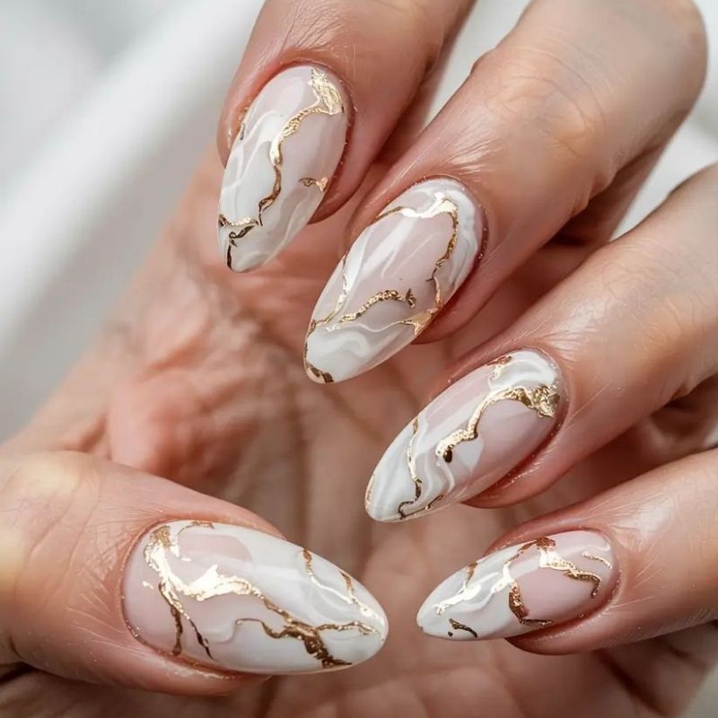 Elegant marble nails using blooming gel with white gray and gold veining details