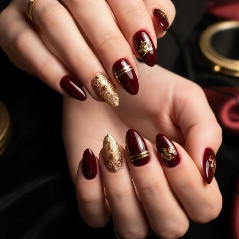 gold chrome christmas nails mixed with burgundy polish accent nails creating elegant two tone metallic holiday design