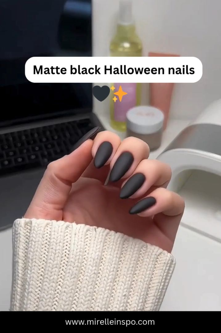 Matte black Halloween nails with glossy accent