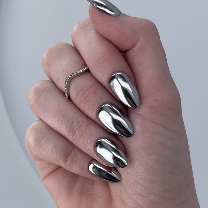Stunning silver chrome new year nails 2025 with champagne glitter accents and metallic finish
