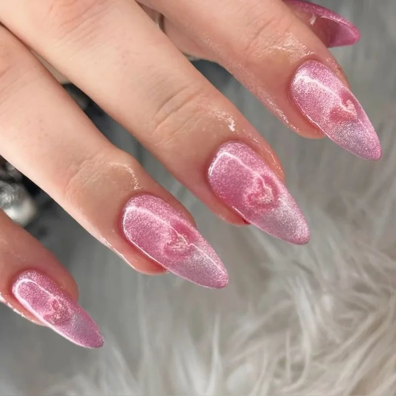 Heart-shaped cat eye design using paperclip magnet technique for Valentine nail art