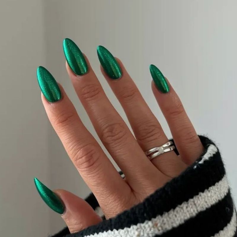 bright emerald green christmas nails with chrome metallic finish jewel tone on almond shape