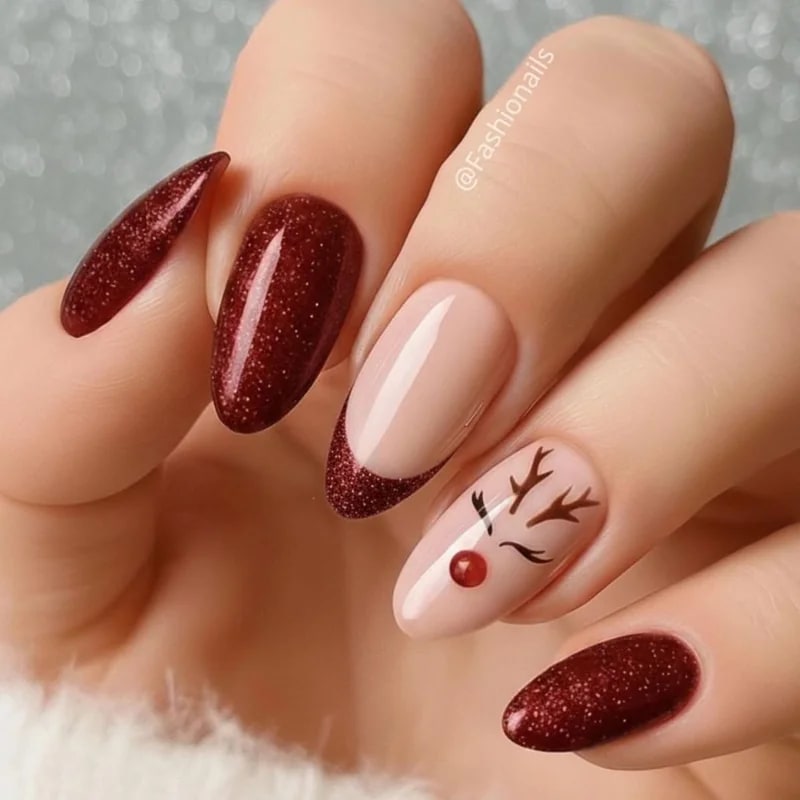Rudolph reindeer nail art featuring brown face, black antlers, and glossy red nose