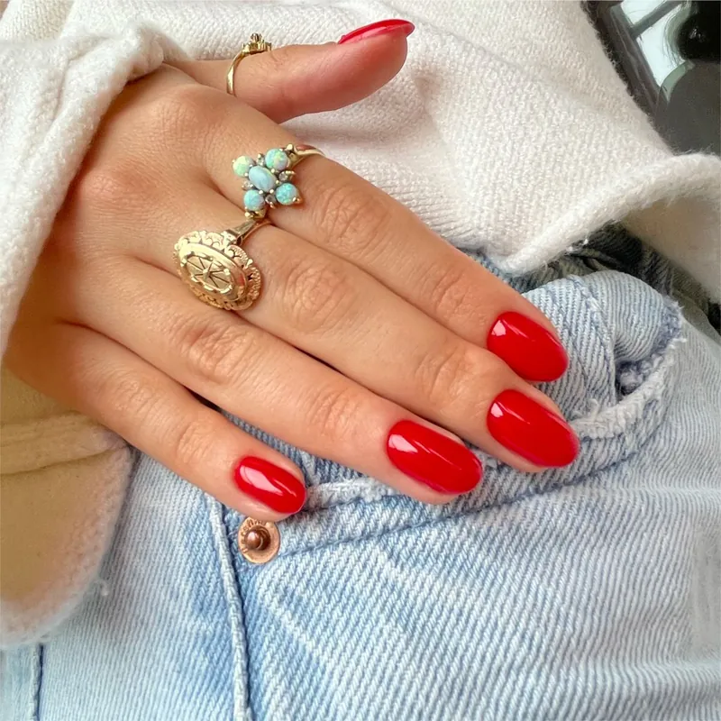 Tomato red nails shown in multiple seasonal contexts demonstrating year-round wearability beyond Valentine