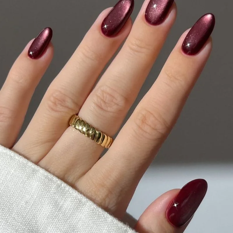 Velvet cat eye nails in burgundy with matte shimmer