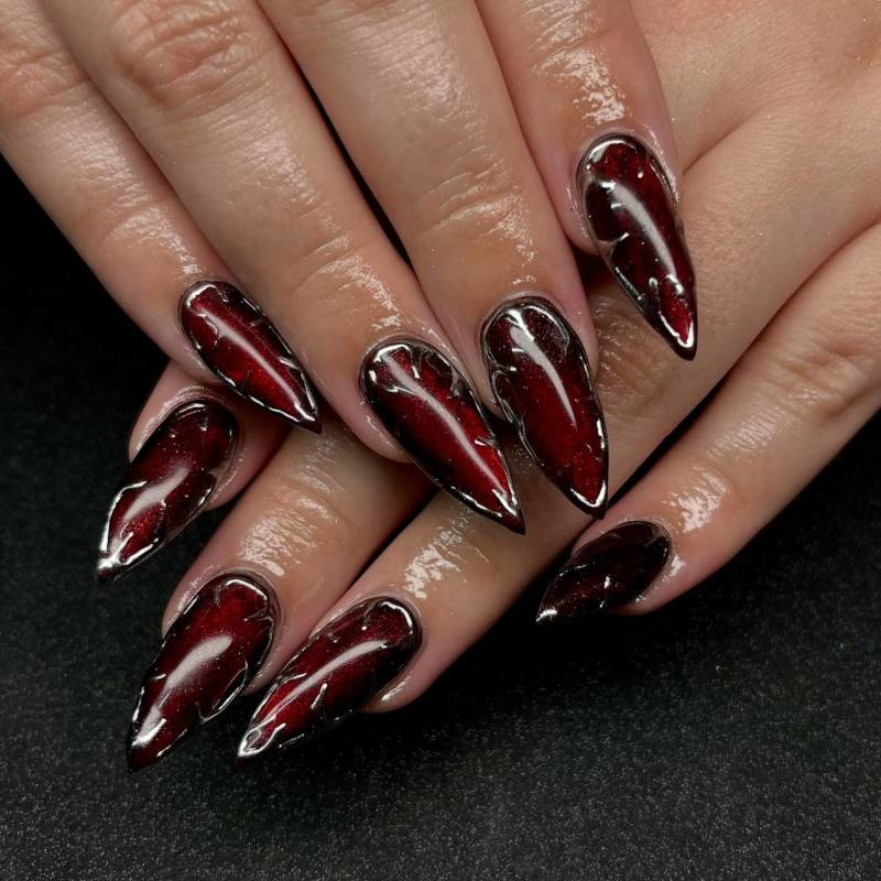 Gothic vampire nails with rhinestones and metallic accents