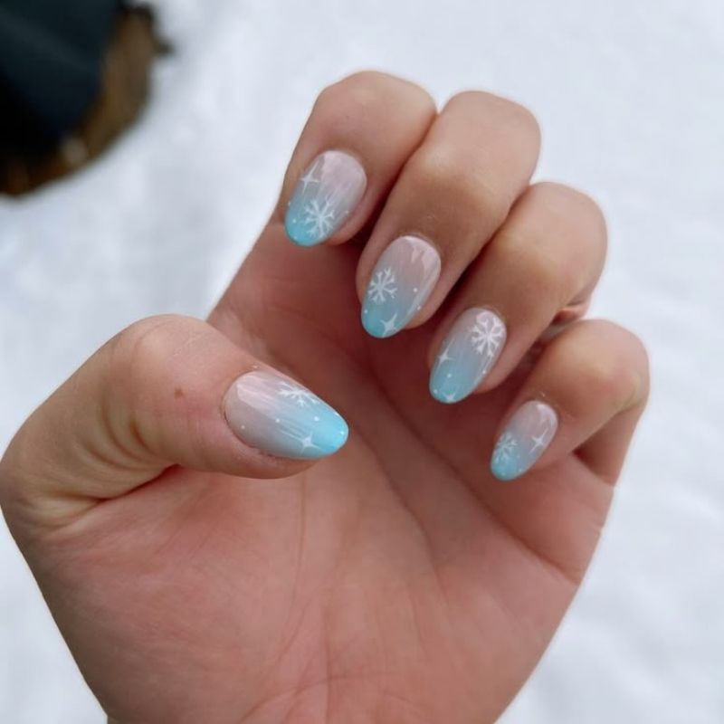 icy blue and white ombre gradient christmas nails frosty winter design with shimmer finish on coffin nails