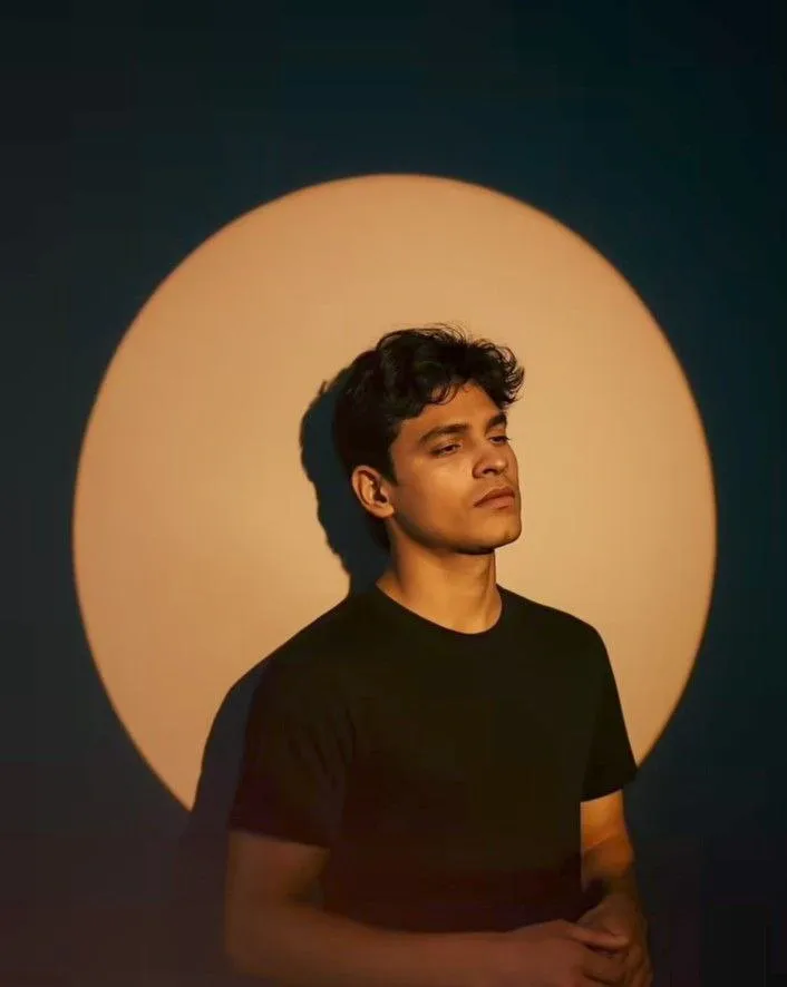 Moody Cinematic Portrait with Golden Spotlight on Navy Background