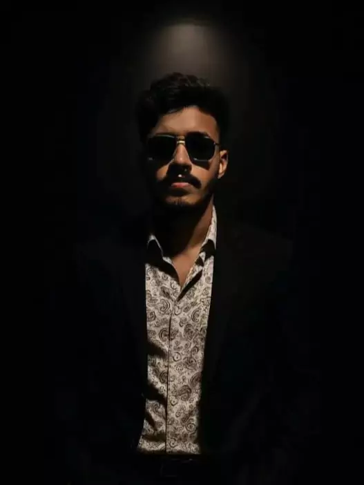 Dramatic Spotlight Portrait in Black Suit and Sunglasses