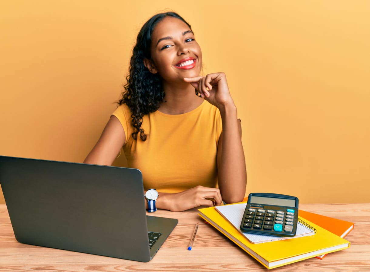 Woman smiling whilst using mac