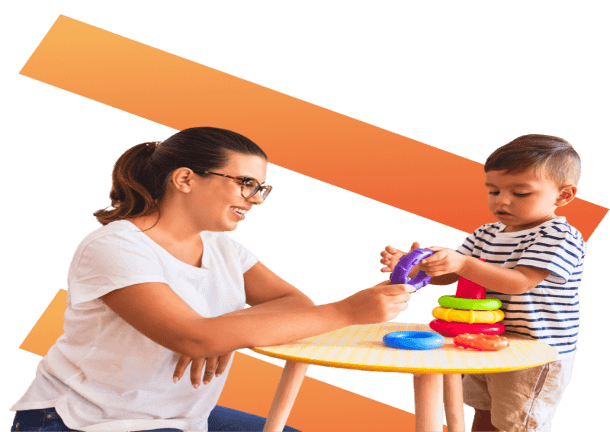 Nursery worker playing with child