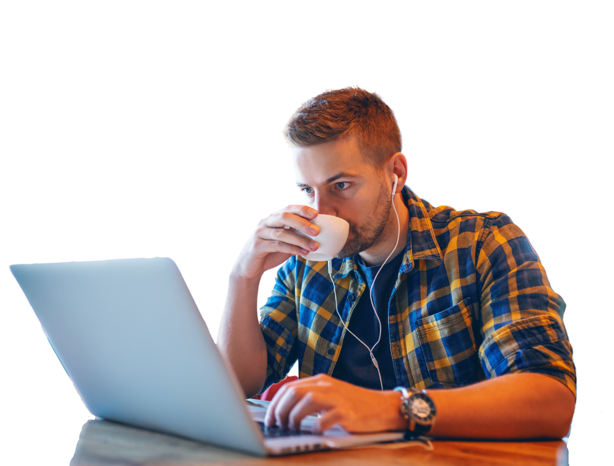 Man sipping coffee in front of laptop