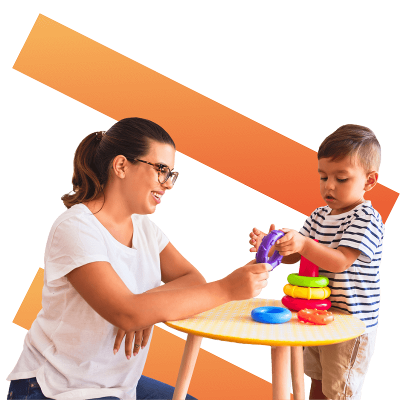 Nursery worker playing with child